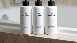 Three bottles of Balmain Paris body wash, shampoo, and conditioner on a bathroom counter. - 2 Connecting Suites at a 4.5⭐️ Hotel (Chicago)
