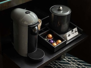 A coffee maker, a black pot, and a box with chocolates on a table. - 2 Connecting Suites at a 4.5⭐️ Hotel (Chicago)