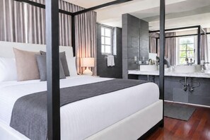 A modern hotel room with a large bed, a separate bathroom, and a view of the outdoors. - 2 Connecting Suites at a 4⭐️ Hotel (Miami Beach)