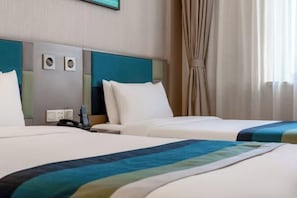 A hotel room with two beds, a headboard with circular decorations, a telephone, and a window with curtains. - Home Inn (Beijing Xueqing Road Agricultural University) (Beijing)