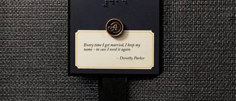 A black address tag with the number 414 and a quote by Dorothy Parker.
