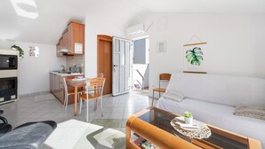 Un appartement moderne comprenant une cuisine, un coin repas et un salon.