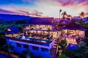 A multi-story resort with a pool, balconies, and tropical surroundings. - Baan Grand Vista - Panoramic Sea View (Koh Samui)