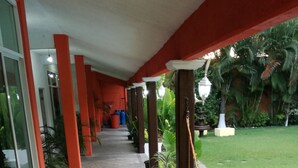 A covered walkway with red pillars, potted plants, and a pool area. - Quinta Olivos!!, UN Espacio Para TU Descanso...!! (Mor.)