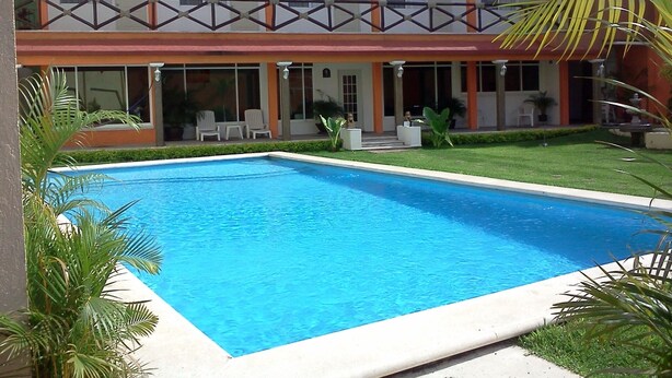 A hotel with a swimming pool, outdoor seating, and a two-story structure. - Quinta Olivos!!, UN Espacio Para TU Descanso...!! (Mor.)