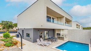A modern two-story house with a swimming pool, outdoor seating, and a garden area. - Awesome home in Liznjan (Liznjan)