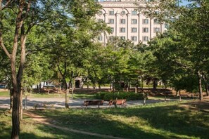 A park with benches, trees, and a building in the background. - Aura Tourist Hotel (Ansan)