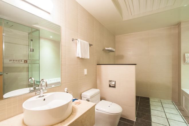 A bathroom with a sink, toilet, and shower.