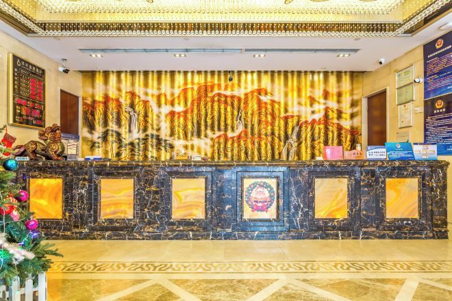 A reception area with a marble counter, framed artwork, and a decorative wall mural.