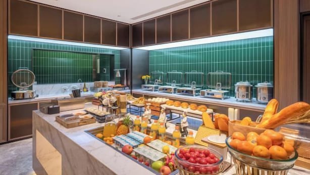 A breakfast buffet with various fruits, pastries, and beverages. - Orange Hotel (Beijing Daxing Biomedical Base Longhu Tianjie Branch) (Beijing)