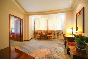 Enjoy a traditional stay with a dining area, mirror, and carpeted floor.