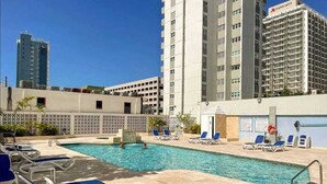 A hotel pool area with lounge chairs and a swimming pool. - Condado Beach Condo - Fast Wi-Fi, AC, Pool & Security 24/7 (San Juan)