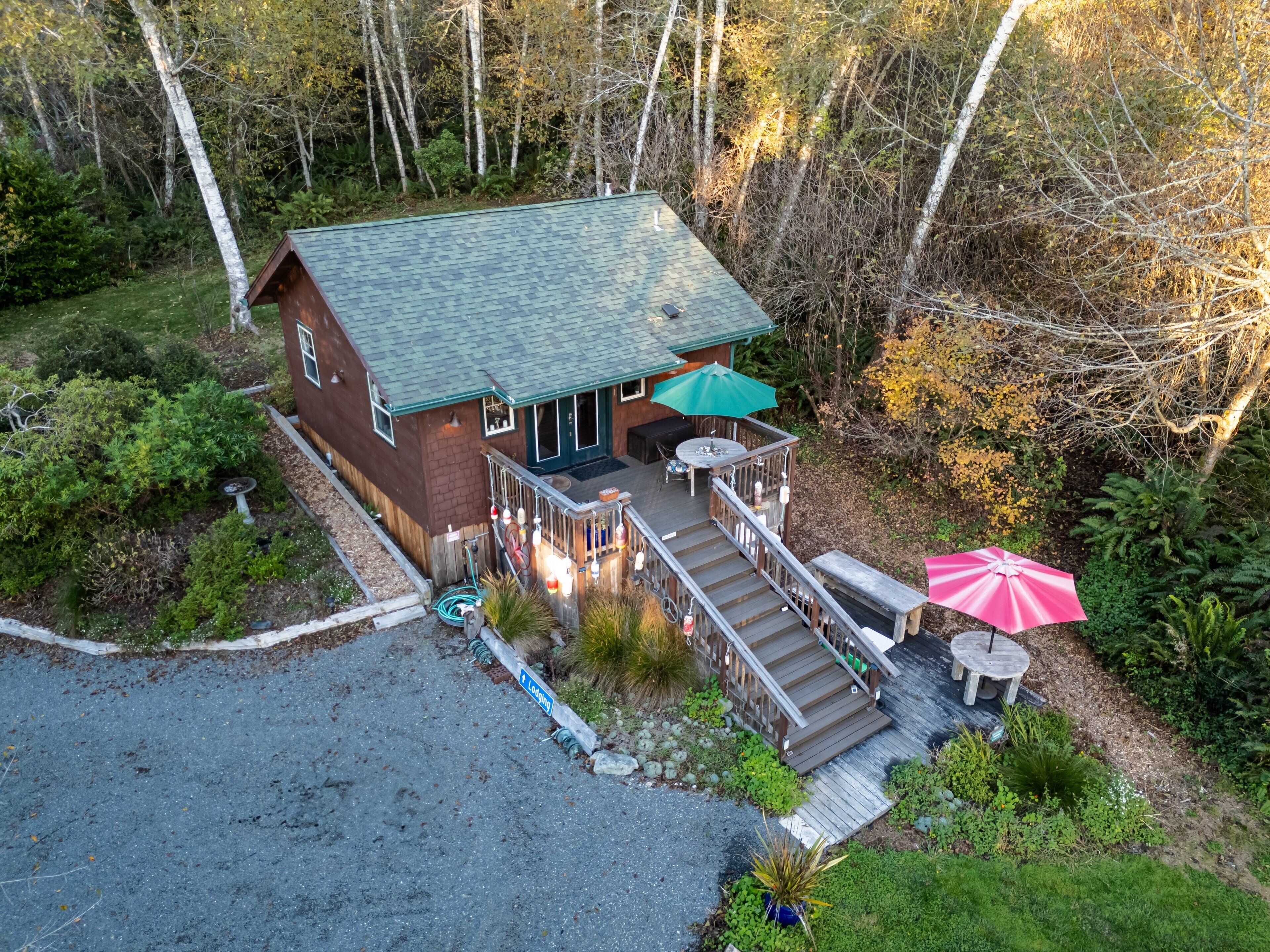 A lodge with a deck, outdoor seating, and a covered patio.