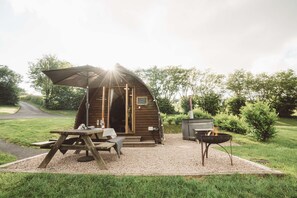 A rustic wooden cabin with a picnic table and a fire pit. - Hot Tub Cabin With Views Over The Brecon Beacons (Brecon)