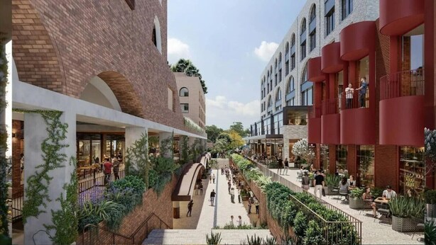 A modern urban plaza with a central pedestrian walkway, surrounded by buildings with brick facades and large windows. - Charming Front Retreat (Surry Hills)