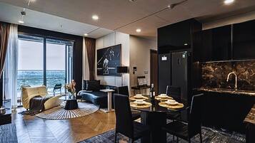 Deluxe Apartment, 3 Bedrooms, City View | Living area | 32-inch Smart TV with cable channels, offices