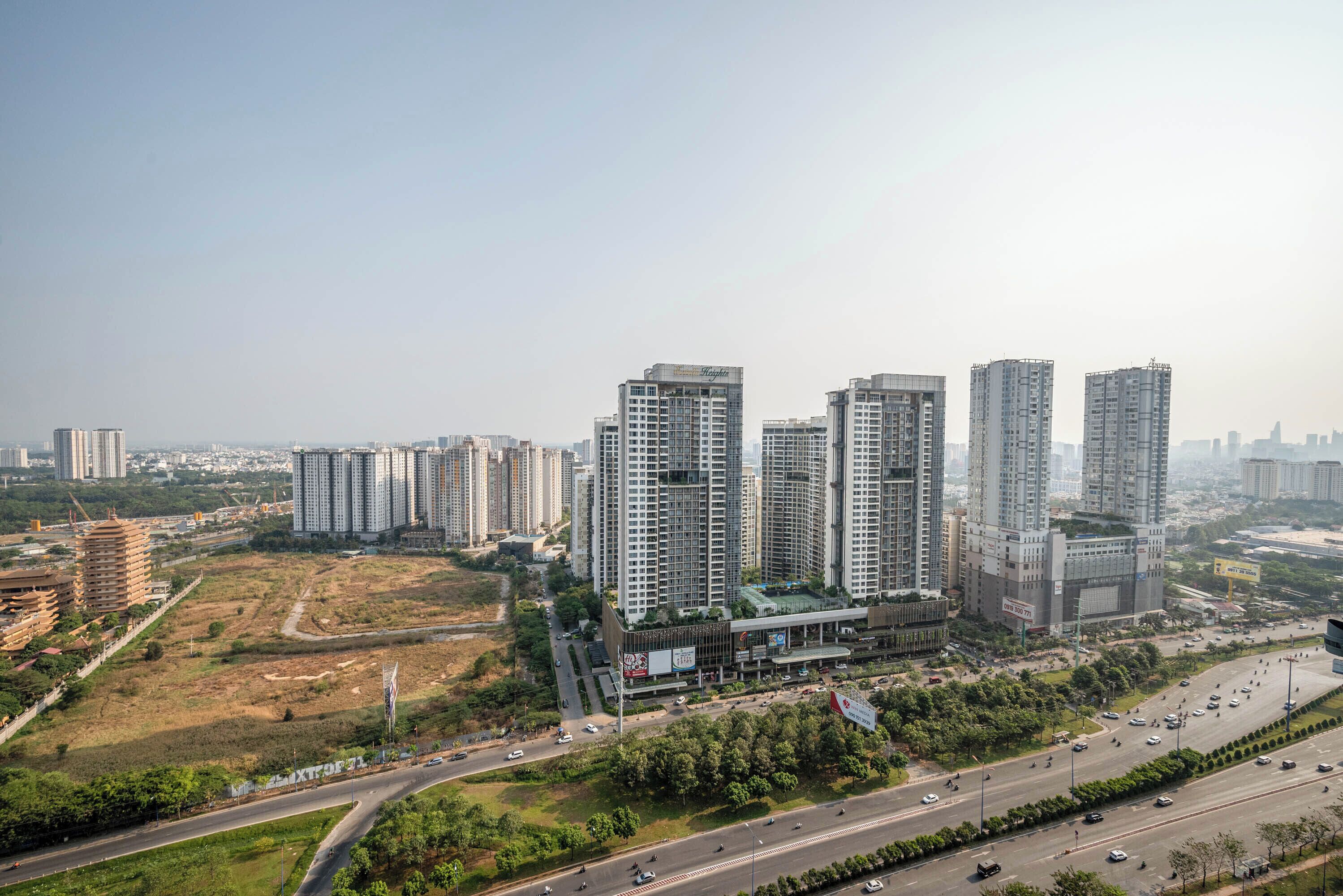 A high-rise building complex with multiple floors, surrounded by roads and greenery.