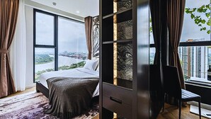 A modern bedroom with a large bed, a built-in wardrobe, a desk, and a view of a cityscape. - The Lumiere Luxury Citypoint ANGIA (Ho Chi Minh City)