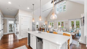 A spacious kitchen with a large island, white cabinetry, and pendant lighting. - 3BR WaterColor Escape w/ Beach Club Access, Golf Cart, 4 Bikes & Spacious Deck for Outdoor Dining. (Santa Rosa Beach)