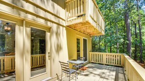 A wooden deck with a table and chairs, surrounded by trees. - Private Balcony: Lake Keowee Home w/ Pool Access (Salem)