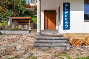 A stone-paved entrance with a wooden door and steps leading to a building labeled 'BLUEBERRY.'