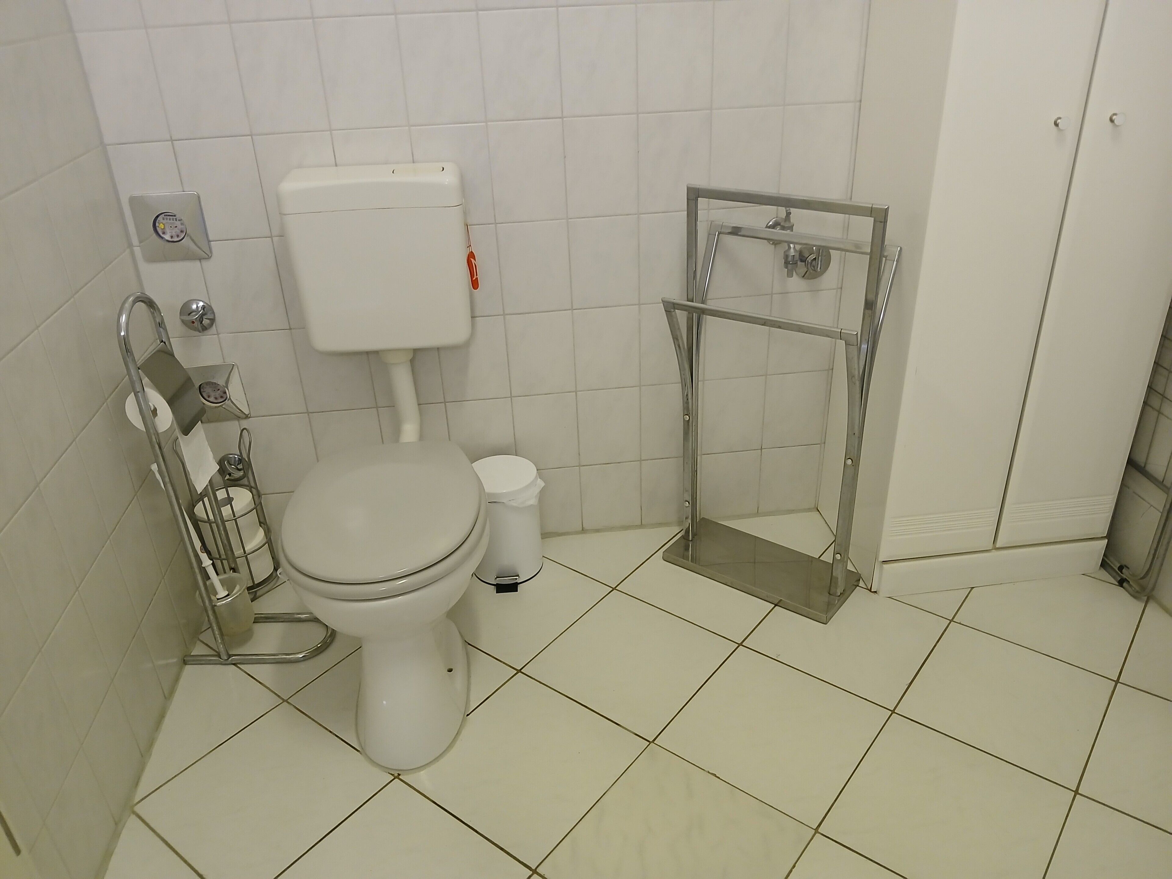 A bathroom with a toilet, a bidet, and a shower stall.