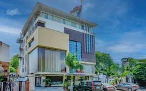 A modern hotel with a flat roof, large windows, and a visible bar sign. - Hotel Aditya Park Regent (Jaipur)