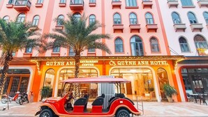 A hotel with a classic facade, featuring multiple balconies and large windows. - Quynh Anh Hotel Ha Long (Bai Chay)