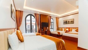 A hotel room with two beds, a TV, and a painting on the wall. - Quynh Anh Hotel Ha Long (Bai Chay)