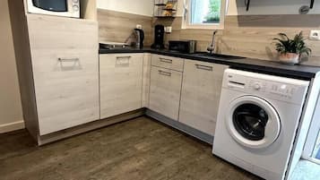 Fridge, microwave, coffee/tea maker, cookware/dishes/utensils