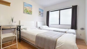 A hotel room with two beds, a desk, a radiator, and a window with curtains. - 202】 【7:00 IN/19:00 OUT】4min丨Nearby Shinjuku and Kabukicho area by train丨Only bath and kitchen丨Maximum 3 persons (Nakano City)