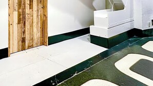 A staircase with a wooden door and white walls. - 202】 【7:00 IN/19:00 OUT】4min丨Nearby Shinjuku and Kabukicho area by train丨Only bath and kitchen丨Maximum 3 persons (Nakano City)