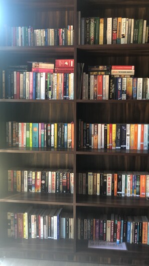 A bookshelf with a variety of books.