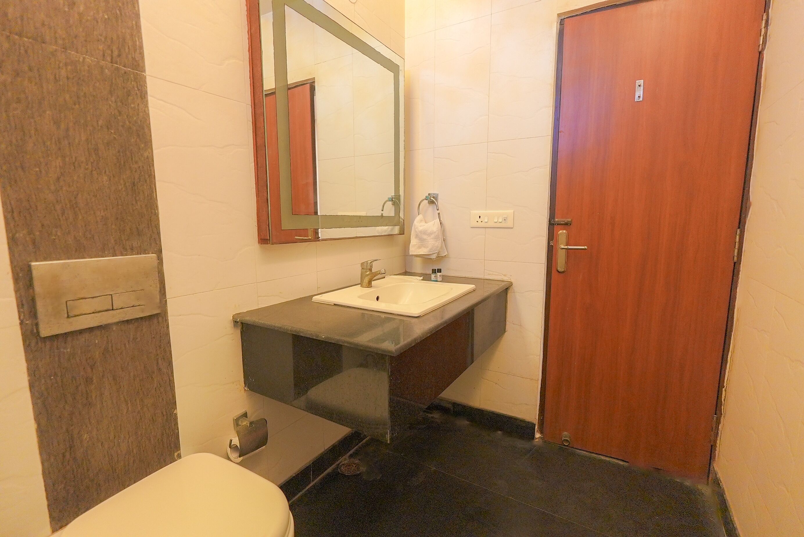 A bathroom with a sink, mirror, and toilet.