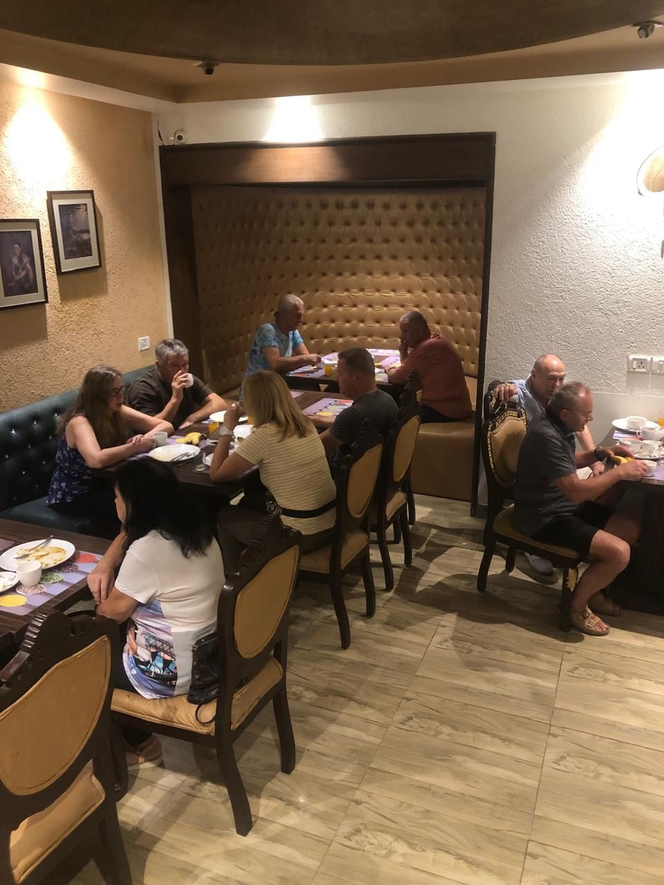 A restaurant with a cozy interior, featuring cushioned seating and a warm, inviting atmosphere.