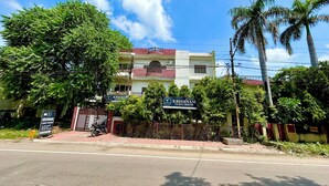 A two-story building with a sign for 'Krishnam Guest House' and a gated entrance. - Krishnam Guest House (Gwalior)