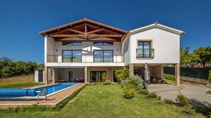 A two-story house with a swimming pool, a covered patio, and a garden. - Contemporary rural villa with large wooden beams with artistic accents (parracheira, Arrabal)