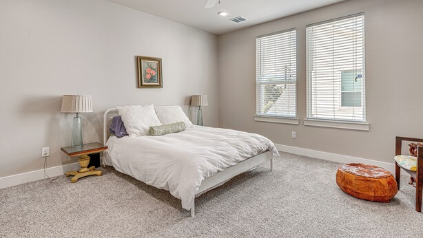 A bedroom with a bed, bedside lamps, a ceiling fan, and a window with blinds. - 2 Mi to Dtown: Convenient Houston Home! (Houston)