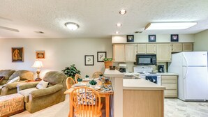 A compact living space with a dining area, kitchen, and seating area. - Little River Condo w/ Pool Access: 5 Mi to Beach (Little River)