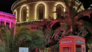 A building with a circular facade and a red telephone booth in the foreground. - Cozy Modern two Bdr Place Sliema Ferry Tigne Point (Sliema)