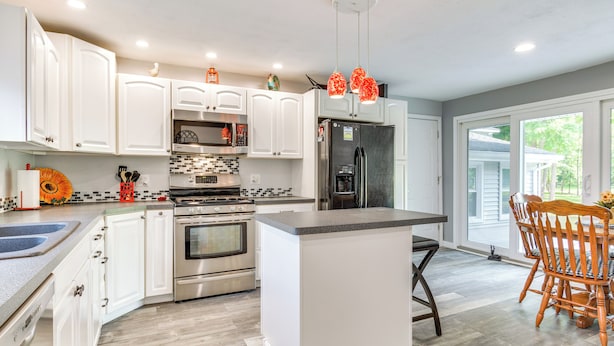 A modern kitchen with white cabinets, stainless steel appliances, and a central island. - Near Trails + Wineries: Victor Getaway w/ Fire Pit (Victor)