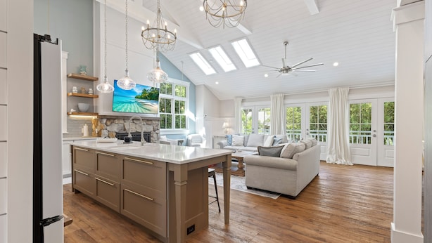 A spacious living area with a large island, a sofa, and a television. - 39 Oak Court: Sea Pines Luxury! 5 BR, 5.5 BA Private Pool & Spa, Bikes (Hilton Head Island)