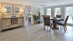 A dining area with a wooden table and chairs, a buffet cabinet, and framed artwork on the wall. - The Clubhouse Murrells Inlet (Murrells Inlet)