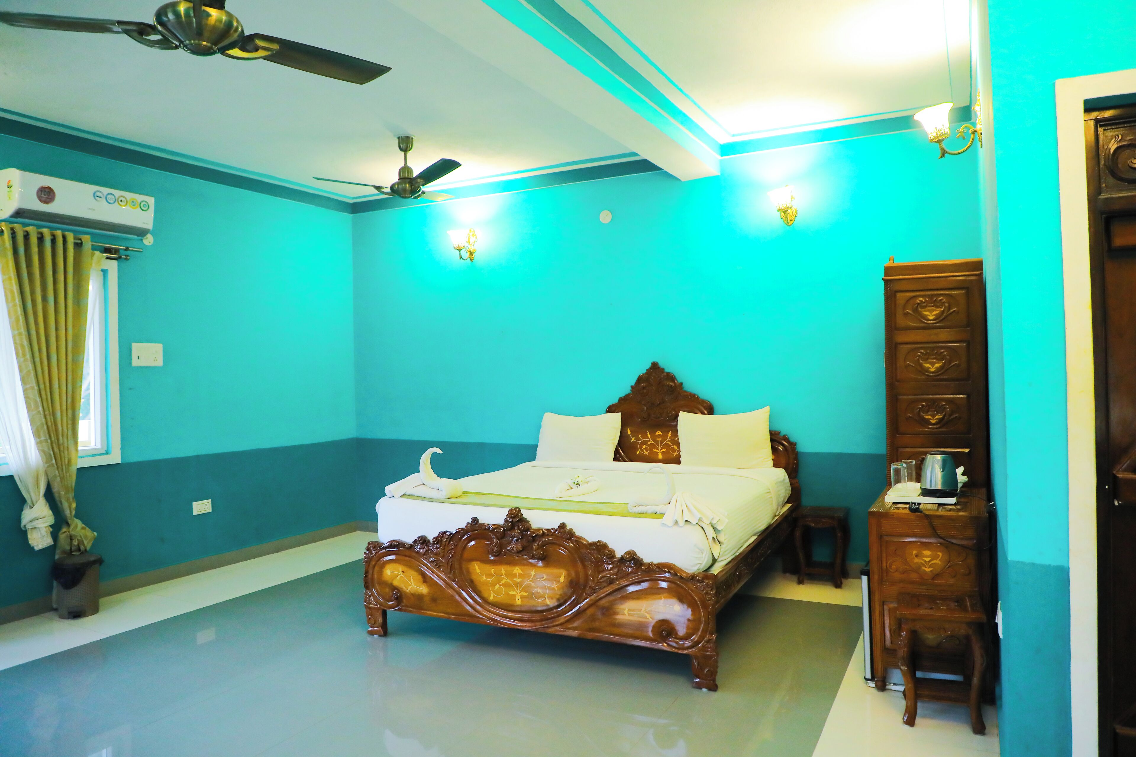 A bedroom with a bed, a dresser, a ceiling fan, and an air conditioning unit.