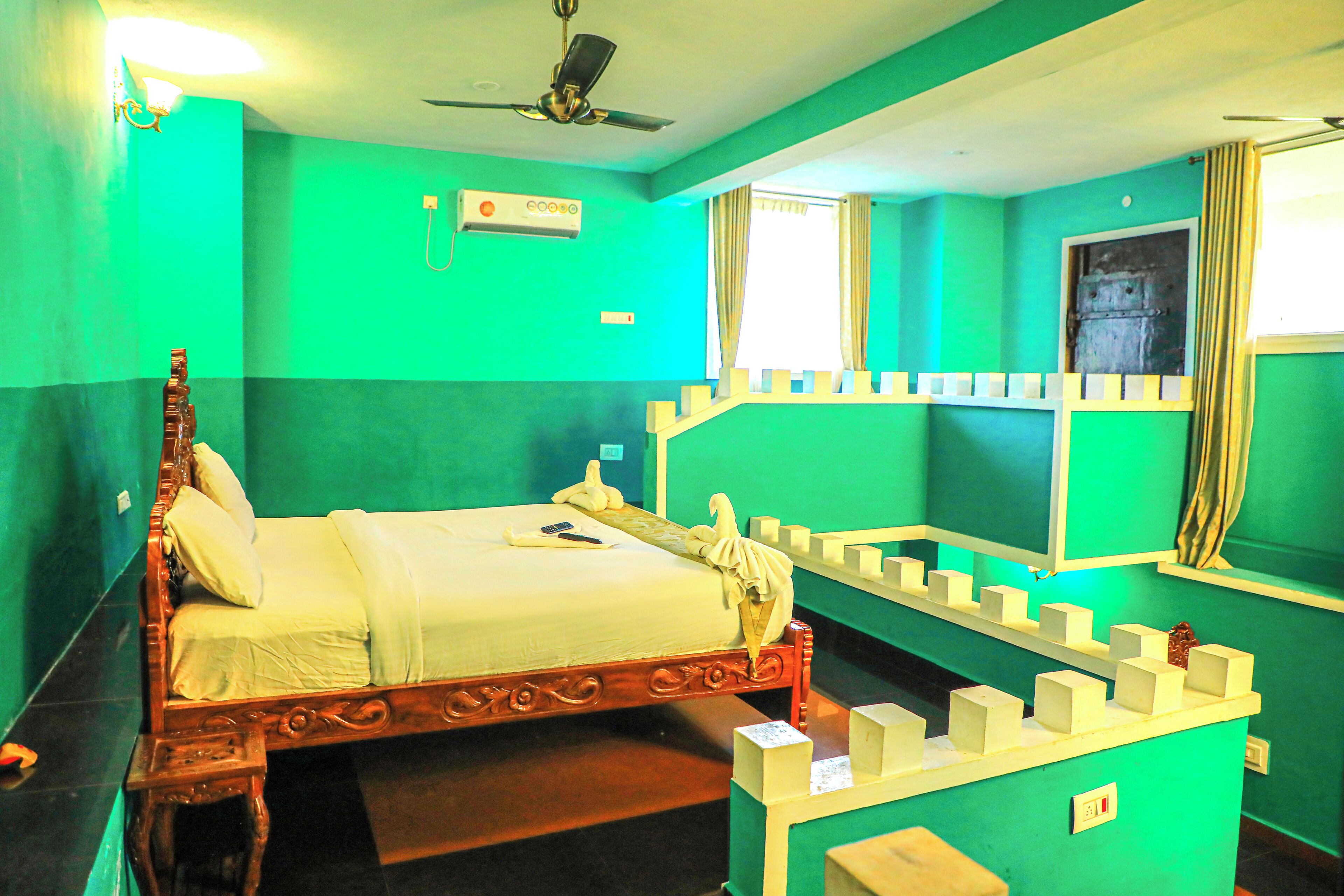 A room with a wooden bed, a ceiling fan, a window with curtains, and a wall-mounted air conditioner.