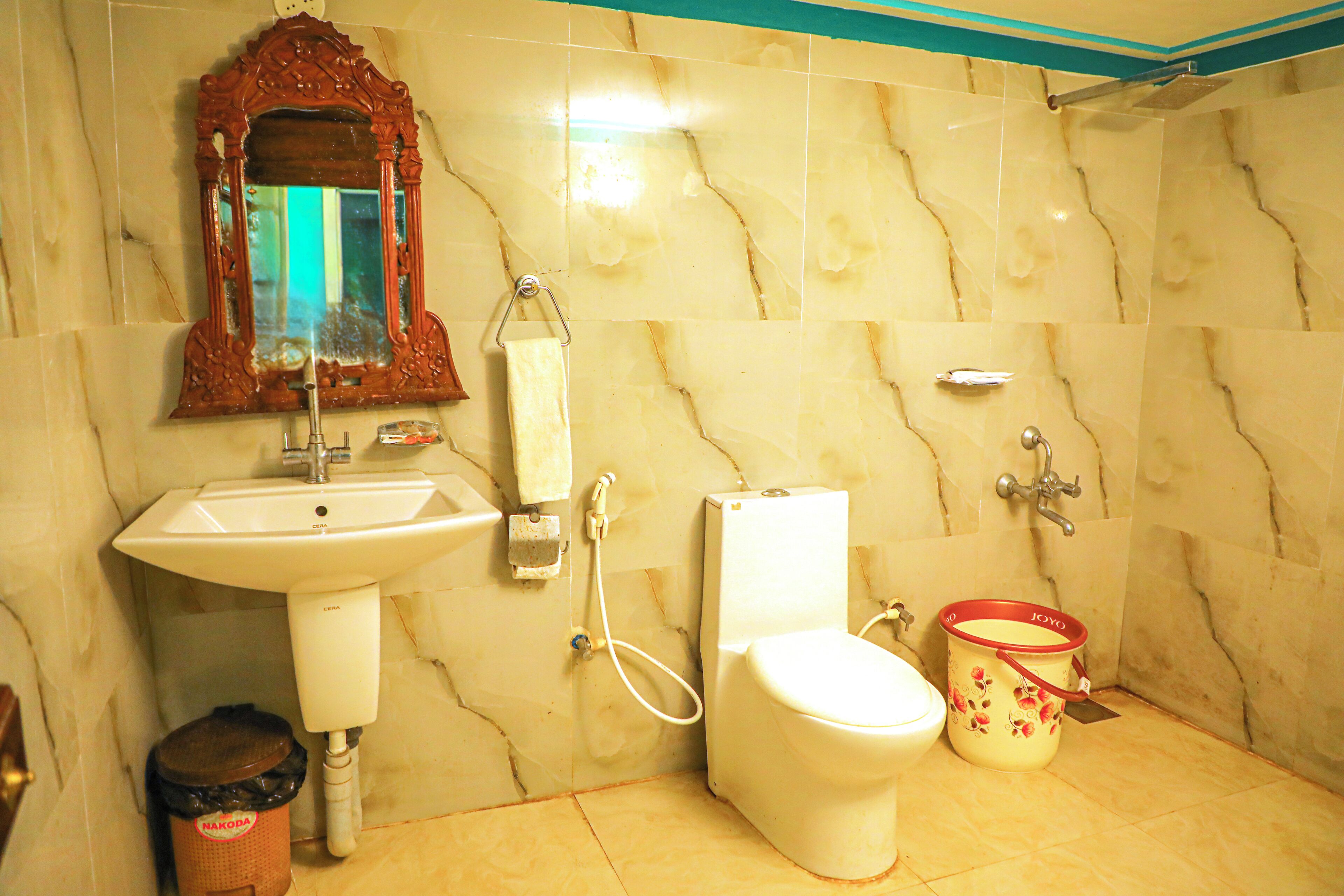 A bathroom with a sink, toilet, and a mirror.