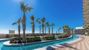 A swimming pool with palm trees and a view of the ocean. - Beach Front, Upscale 27th Floor - Phoenix West 2704, 3 bedroom, New Rental! (Orange Beach)
