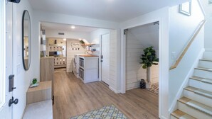 A modern kitchen with wooden flooring, a built-in oven, and a sink. - Home in Duck near the beach, shopping & dining! (Duck)
