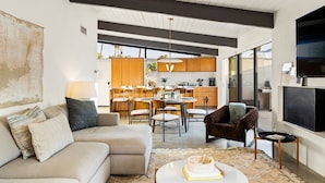 A modern living room with a sofa, a coffee table, and a TV. - 30+ Stay! Gorgeous Home W/Pool/Spa/Mtn Views (Palm Springs)