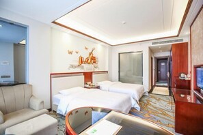 A hotel room with two beds, a sofa, a TV, and a wall with a musical note design. - Vienna International Hotel (Mount Emei Crystal Plaza Hotel) (Emeishan City)